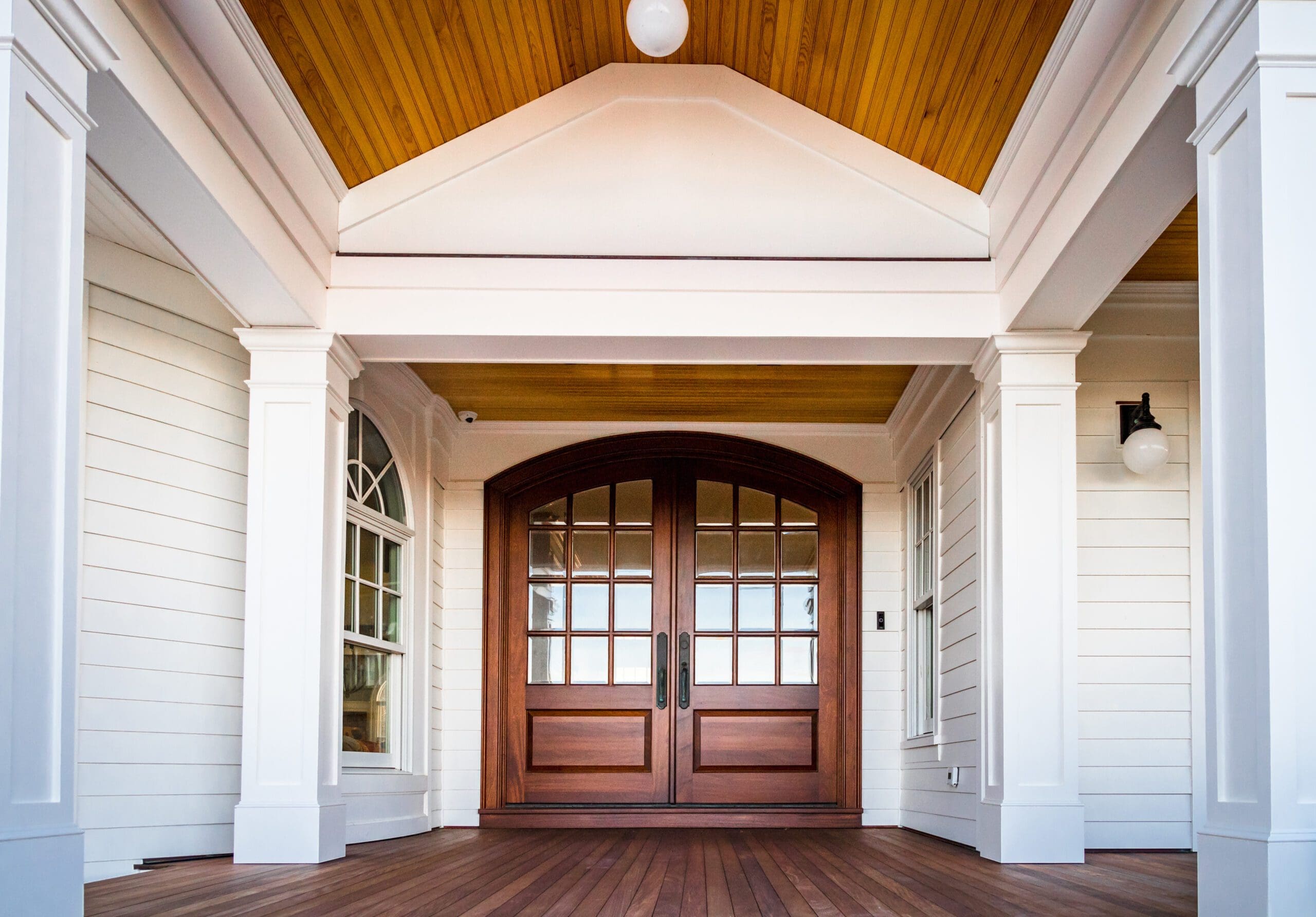 Front entry way of house featuring PVC trim, woodwork, columns,