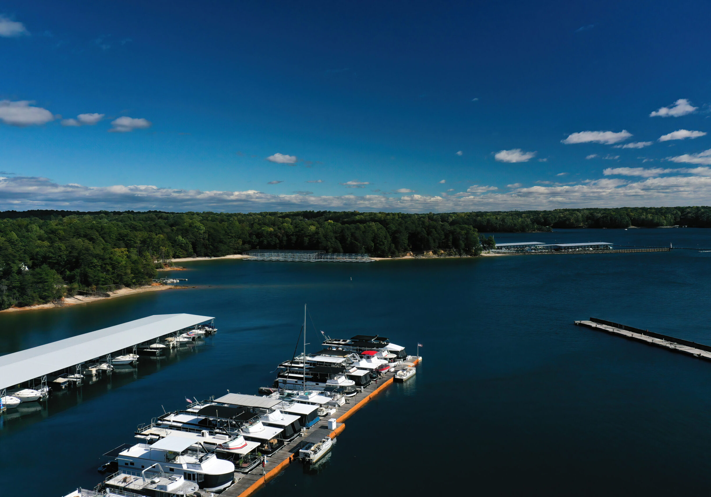 Aerial panoramic view of Lake Lanier and boats docked in the harbor shot by drone on a beautiful sunny day in the fall of 2022